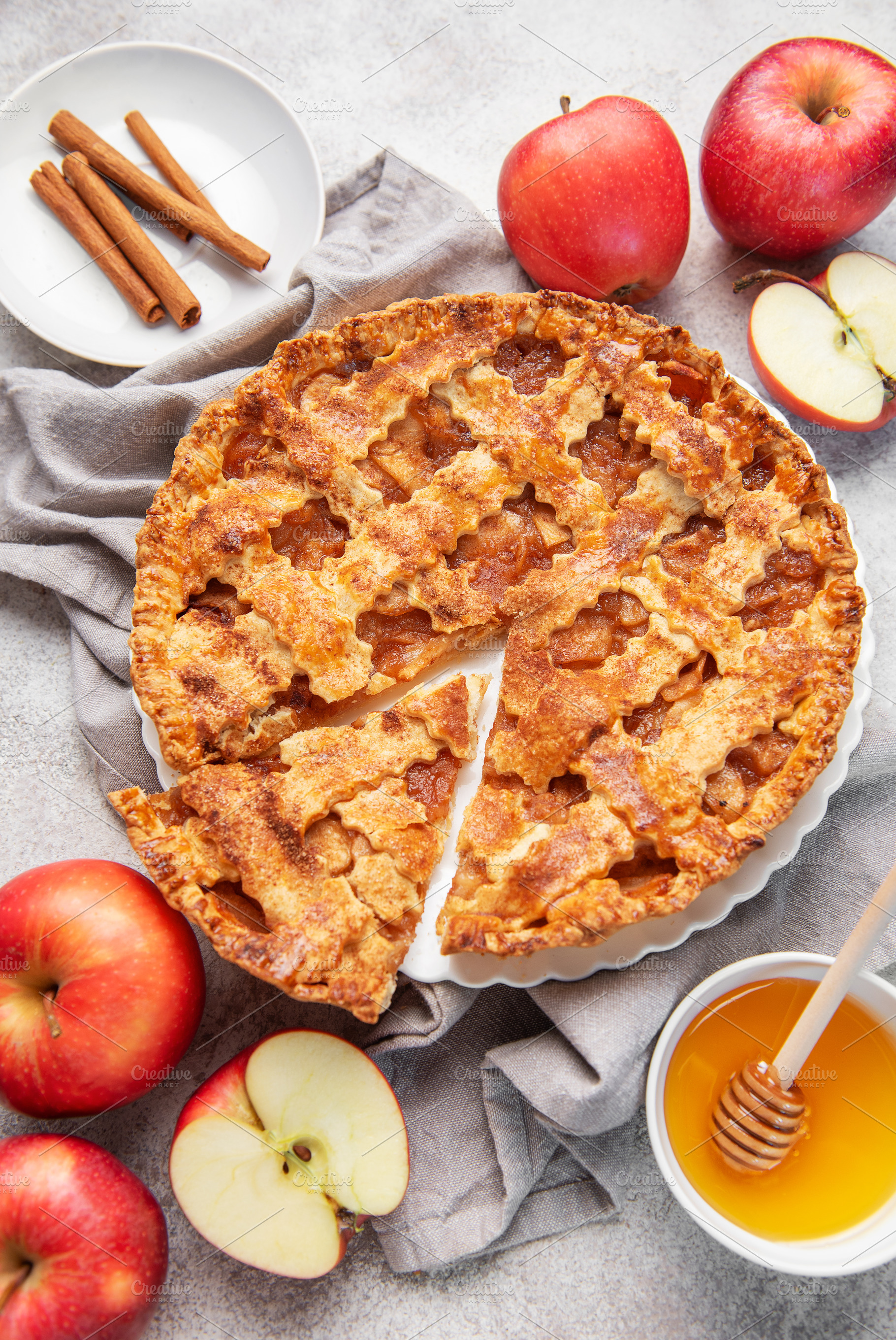 Apple pie with lattice crust, cinnamon sticks, fresh apples, hon, a Food & Drink Photo by Olena Rudo