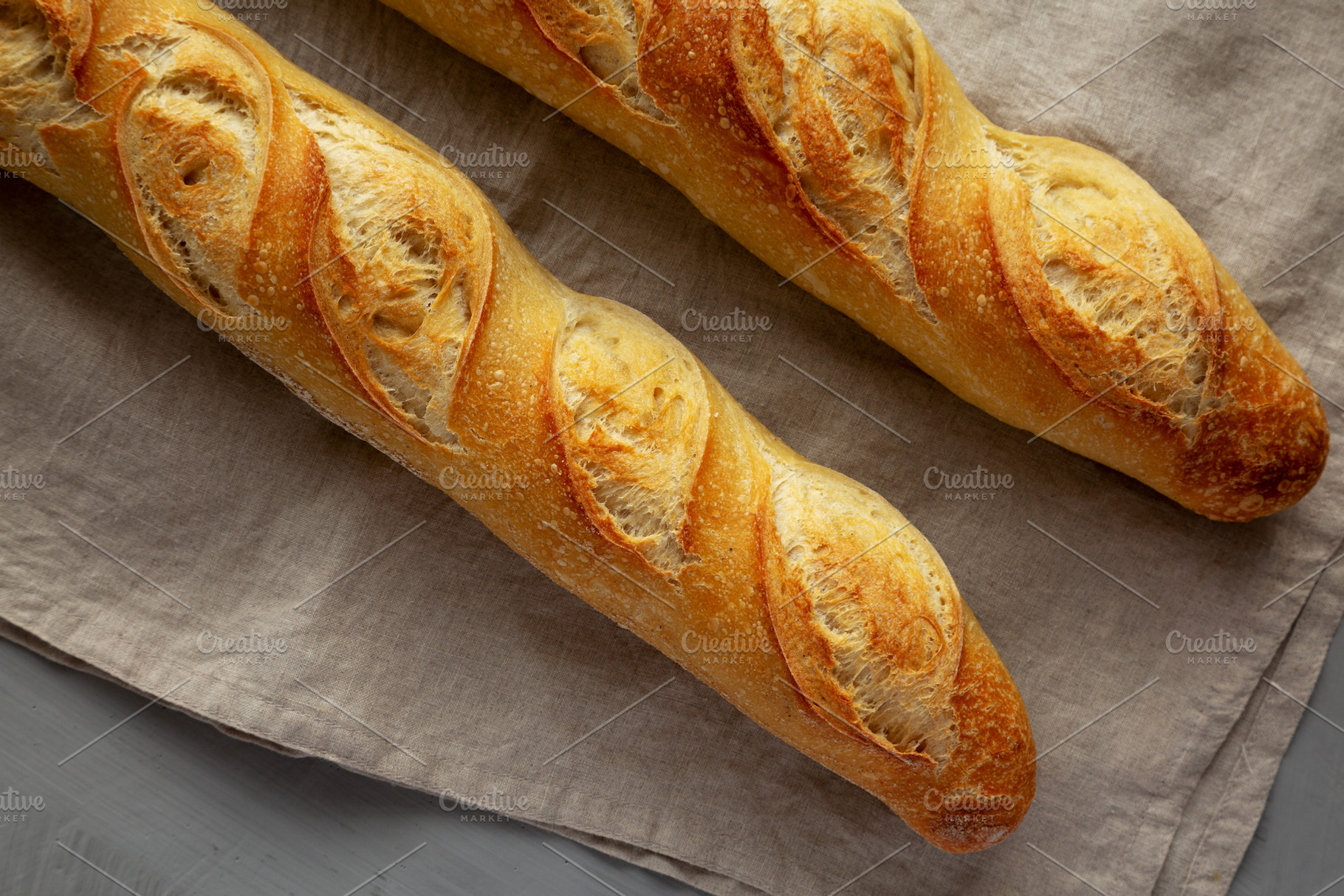 Homemade French Bread Baguette on a gray background, top view., a Food & Drink Photo by LiudmylaChuhunova