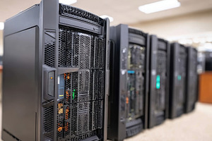 Row of black computer servers in a data center, a Technology Photo by AlyaAnd