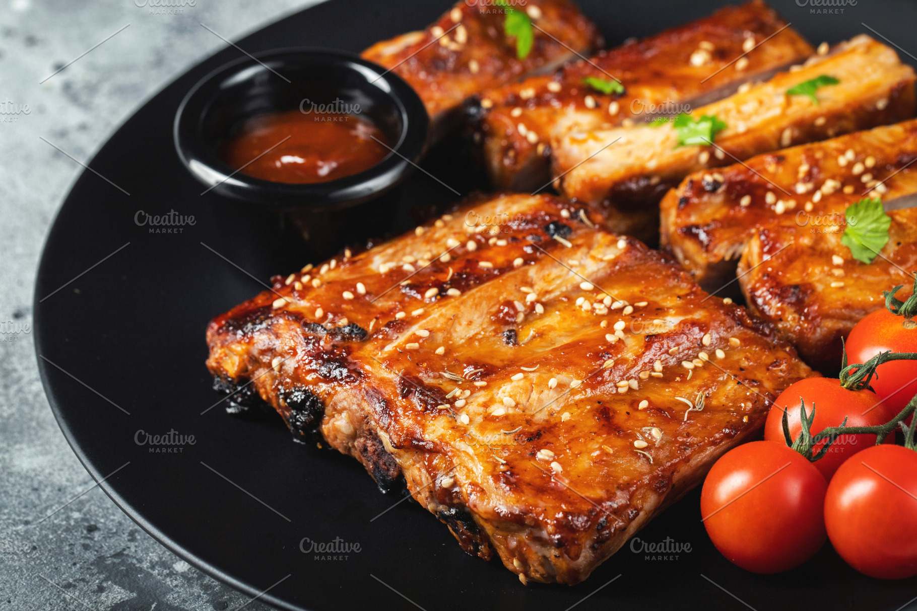 Closeup of pork ribs grilled with BBQ sauce and caramelized in h, a Food & Drink Photo by Budarinphoto