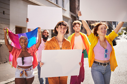 Lgbt protest, poster and group of people walking in city street for activism, human rights and equality. Freedom, diversity and lgbtq community crowd with mockup billboard space for social movement, a Photo by Peopleimages.com