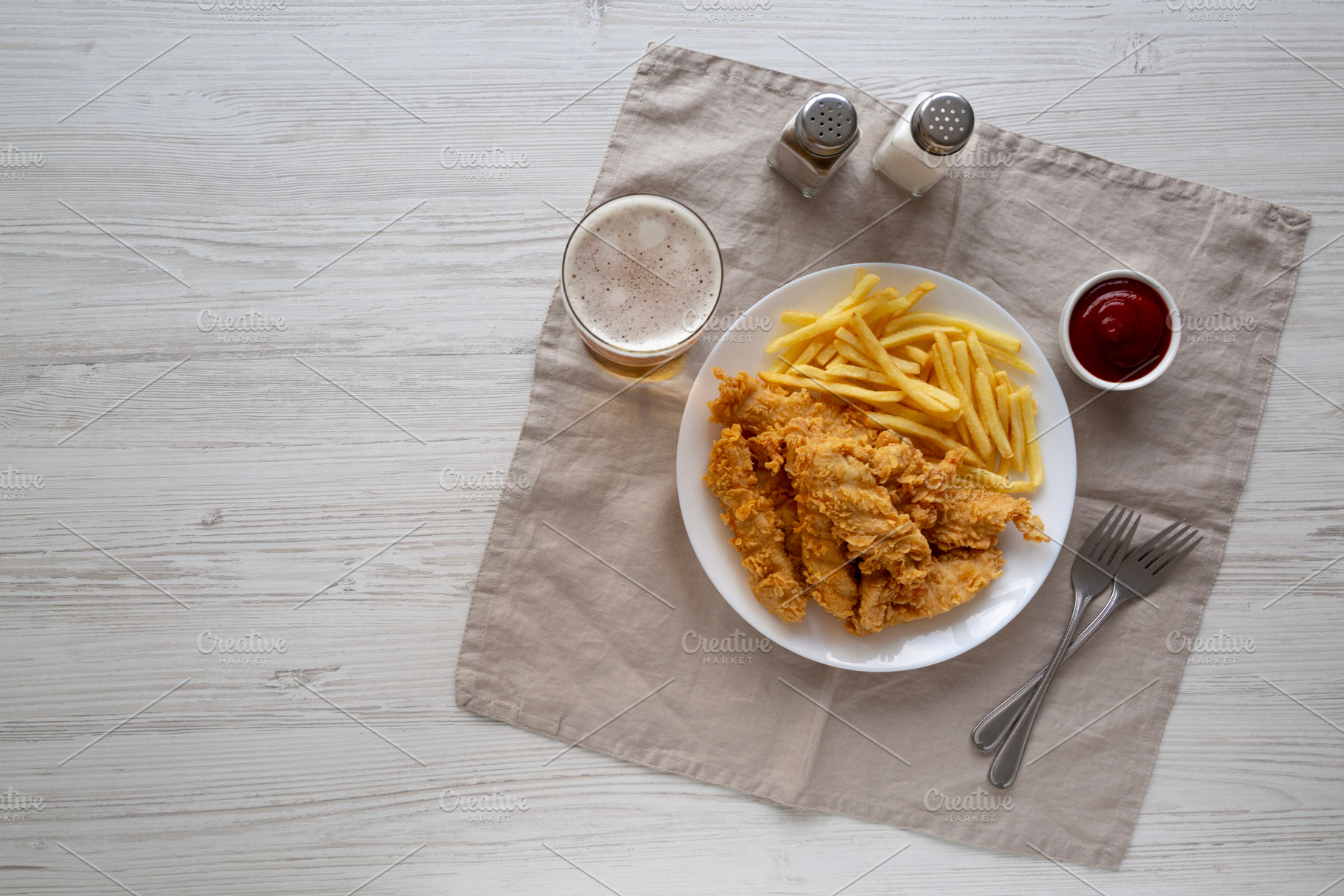 Homemade Chicken Strips with Fries on a Plate, top view. Space f, a Food & Drink Photo by LiudmylaChuhunova