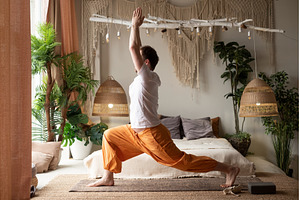 man practicing yoga doing warrior