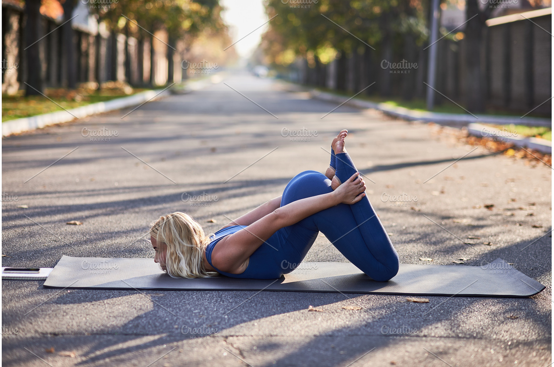 Woman Practicing Yoga in Bow Pose on, a Person Photo by wip3out