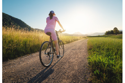 Woman is riding a mountain bike on, a Sports & Recreation Photo by den-belitsky