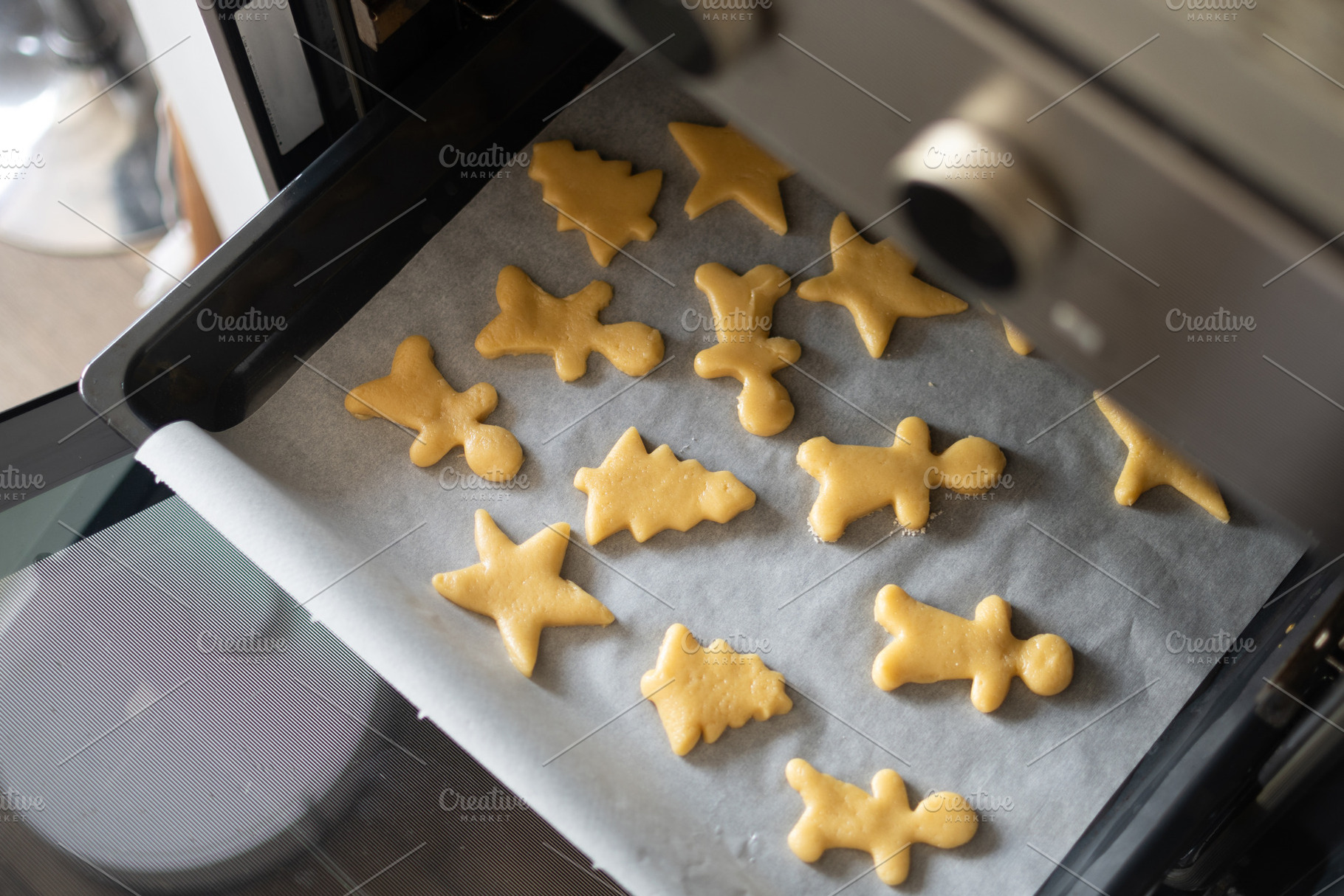 Raw Christmas cookies arranged on baking tray, a Food & Drink Photo by etorres69
