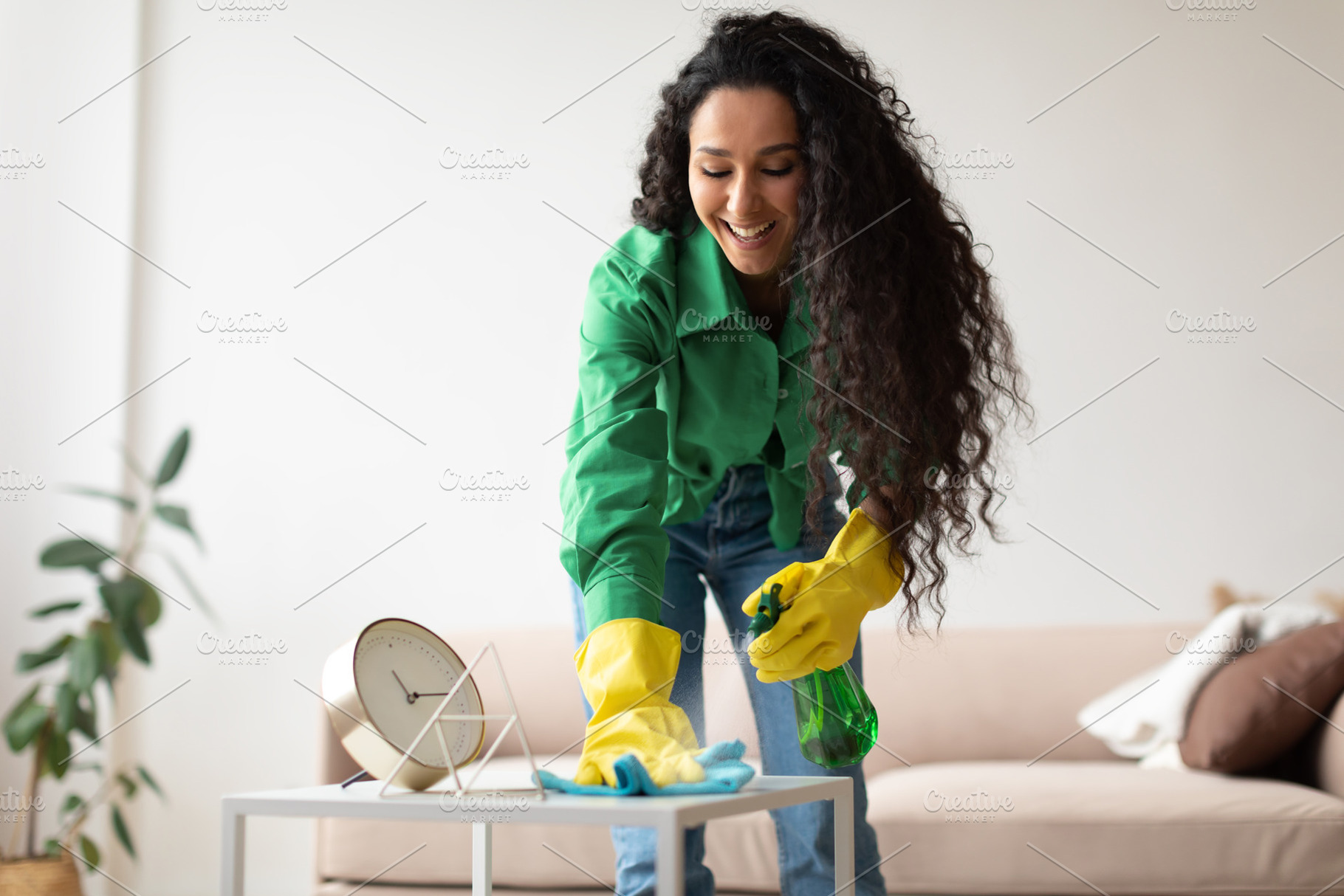 Happy Cleaner Lady Cleaning And Dusting Table At Home, a Photo by Prostock-Studio
