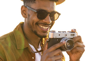 Young man captures memories using a classic film camera isolated, a Person Photo by DanFLCreativo