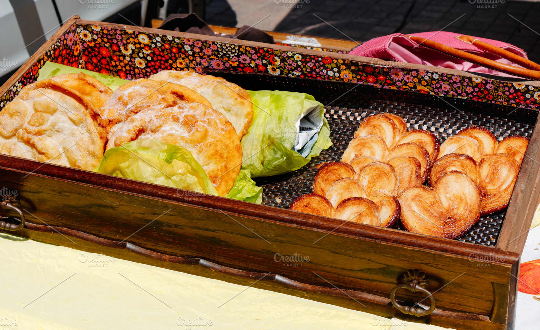 french bougnettes and palmieres on display, a Photo by Nito