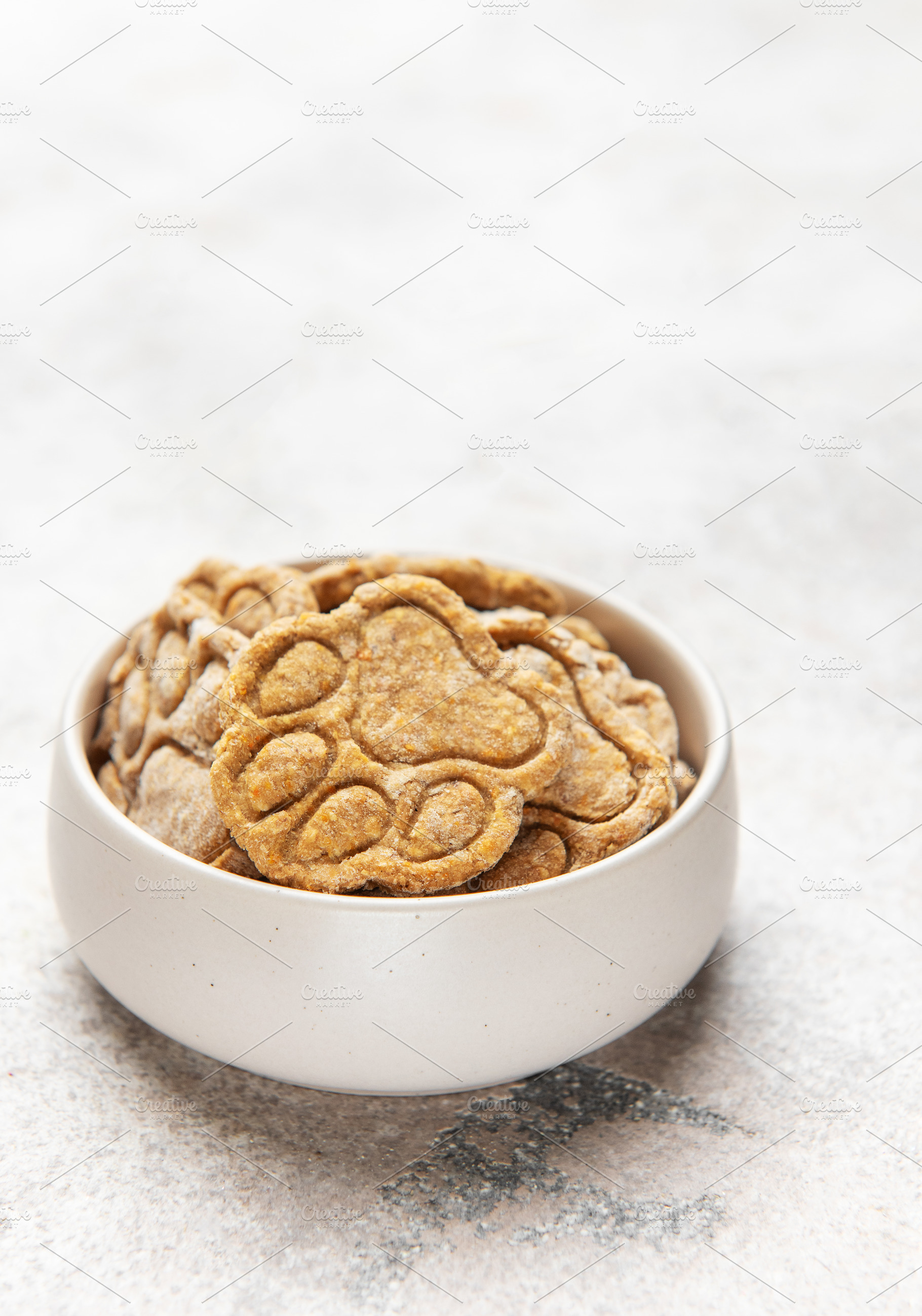 Homemade paw print dog treats in bowl, a Food & Drink Photo by Olena Rudo