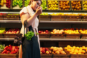 Young woman holding a bag, a Food & Drink Photo by Artem Varnitsin