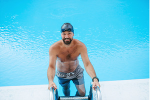 Male swimmer is preparing for swim, a Sports & Recreation Photo by HalfPoint