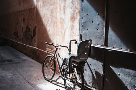 Old bike on a narrow street, a Photo by SkyNext