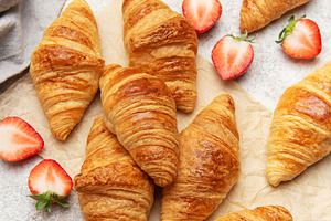 Freshly baked croissants with strawberries and honey for breakfa, a Food & Drink Photo by Olena Rudo