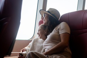 Mother and daughter enjoying ferry journey together by window, a Person Photo by etorres69