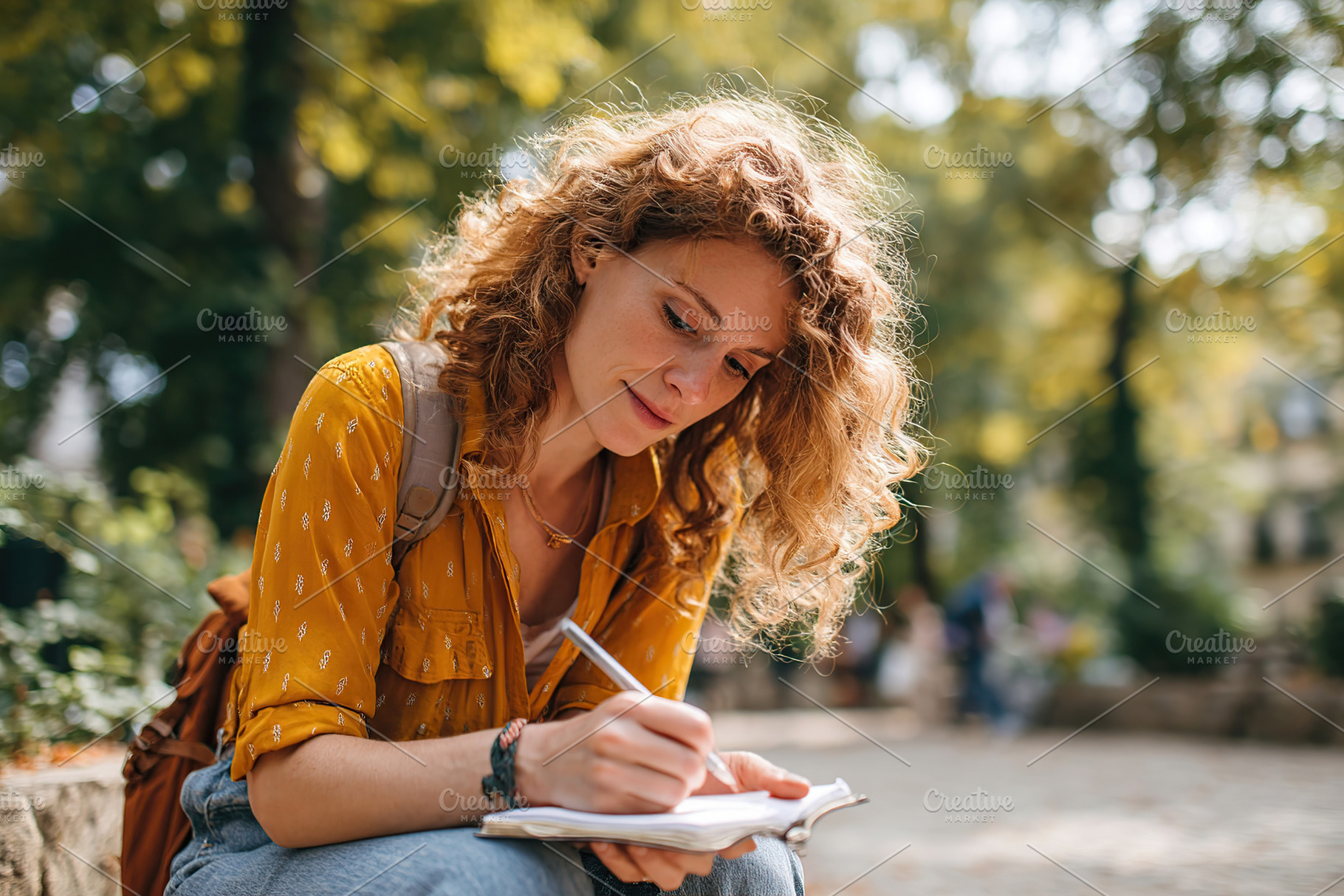 Sketching in a park during lunch break while enjoying nature's beauty, a Person Photo by AlyaAnd