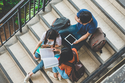 Group of Asian college student using tablet and mobile phone out, a Person Photo by Ministocker