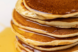 drizzled with honey, a large number of delicious pancakes stacked together on a, a Photo by rsoollAI