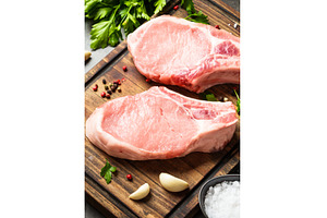 Raw pork meat on cutting board with, a Food & Drink Photo by Nadia-nb