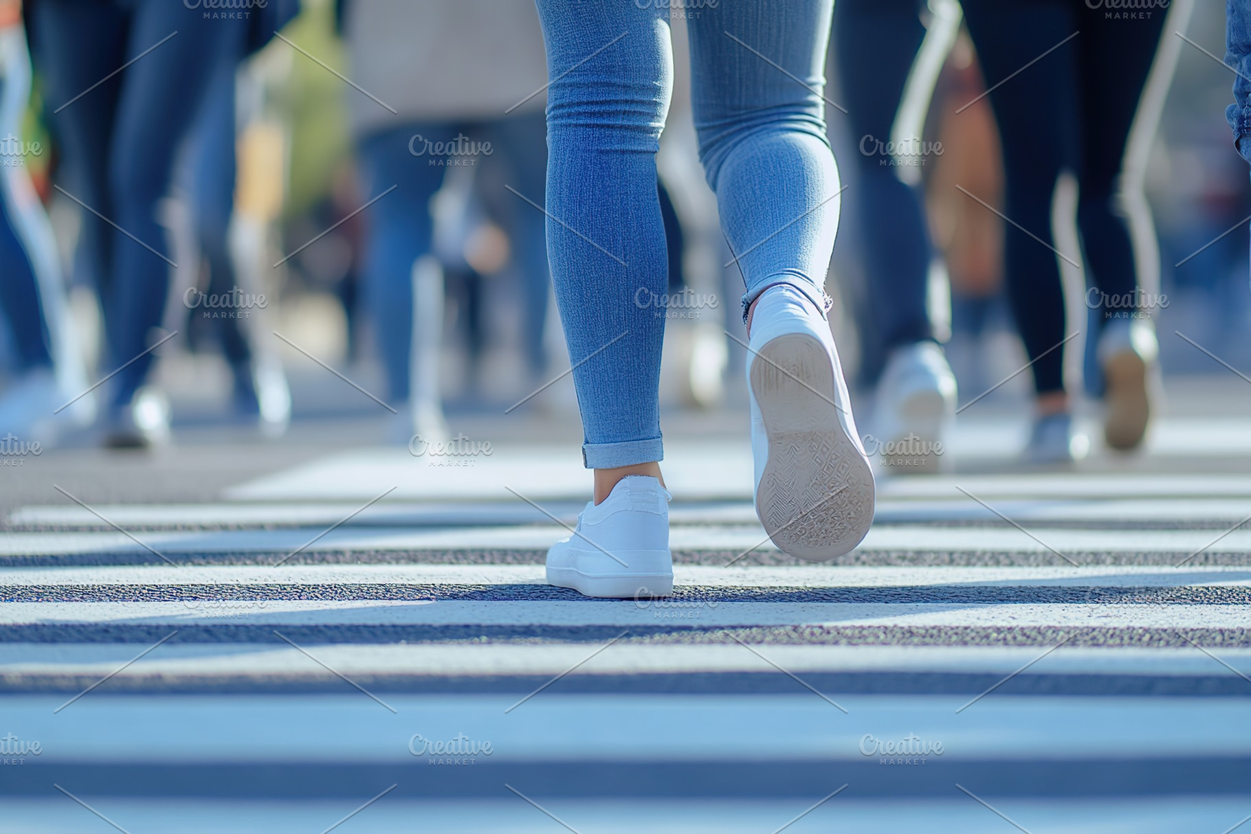 Closeup of people legs crossing the street on the crosswalk, a Person Photo by AlyaAnd