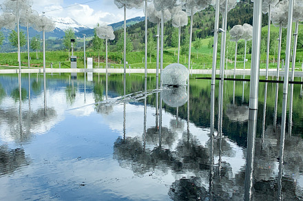 Swarovski museum outdoor installation reflecting on water with s