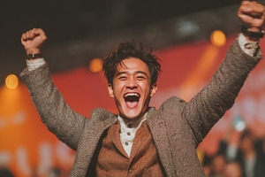 Young asian man celebrating success with excitement and energy at an event, a Person Photo by AS photostudio