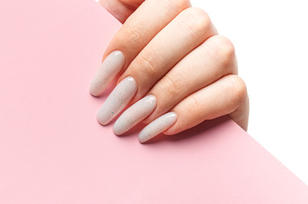 Manicured woman's hand holding pink paper., a Beauty & Fashion Photo by Olena Rudo