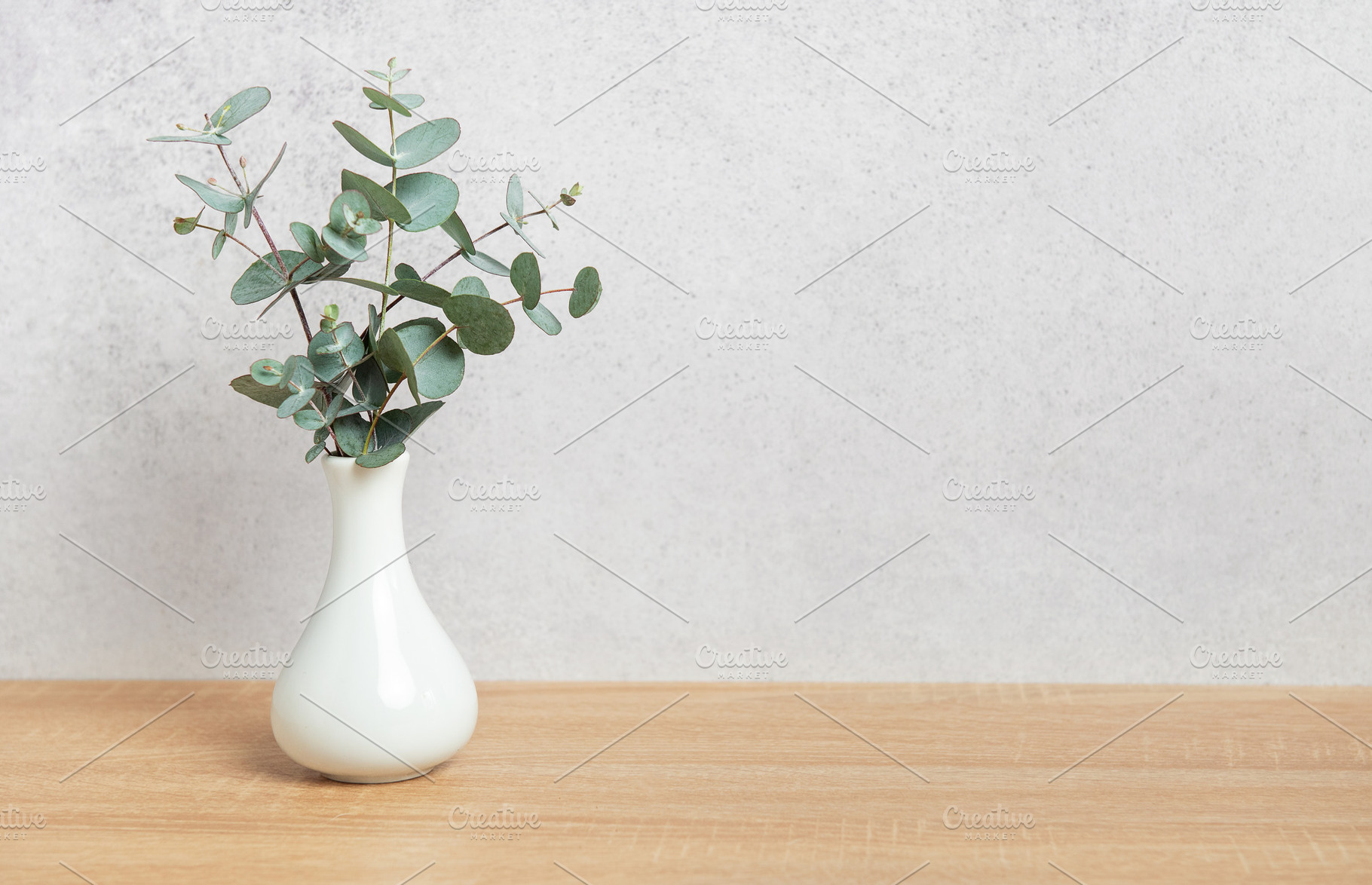 Eucalyptus branches in vase creating a fresh and natural atmosph, a Background Photo by Olena Rudo