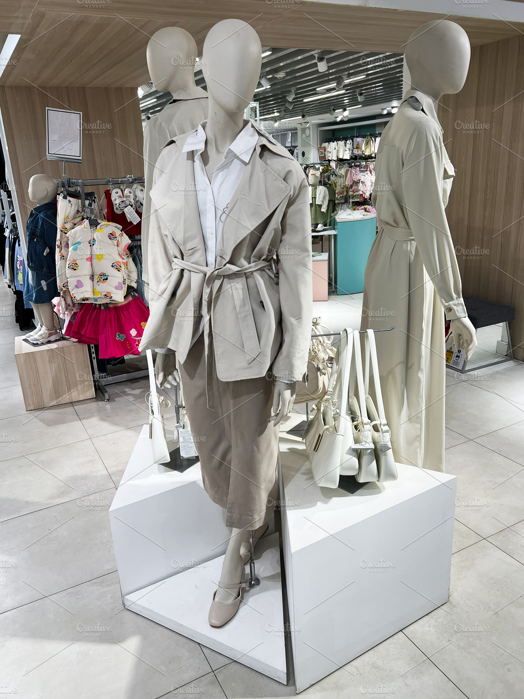 Fashion mannequins showcasing beige clothing styles in a retail display setting, a Photo by AS photostudio