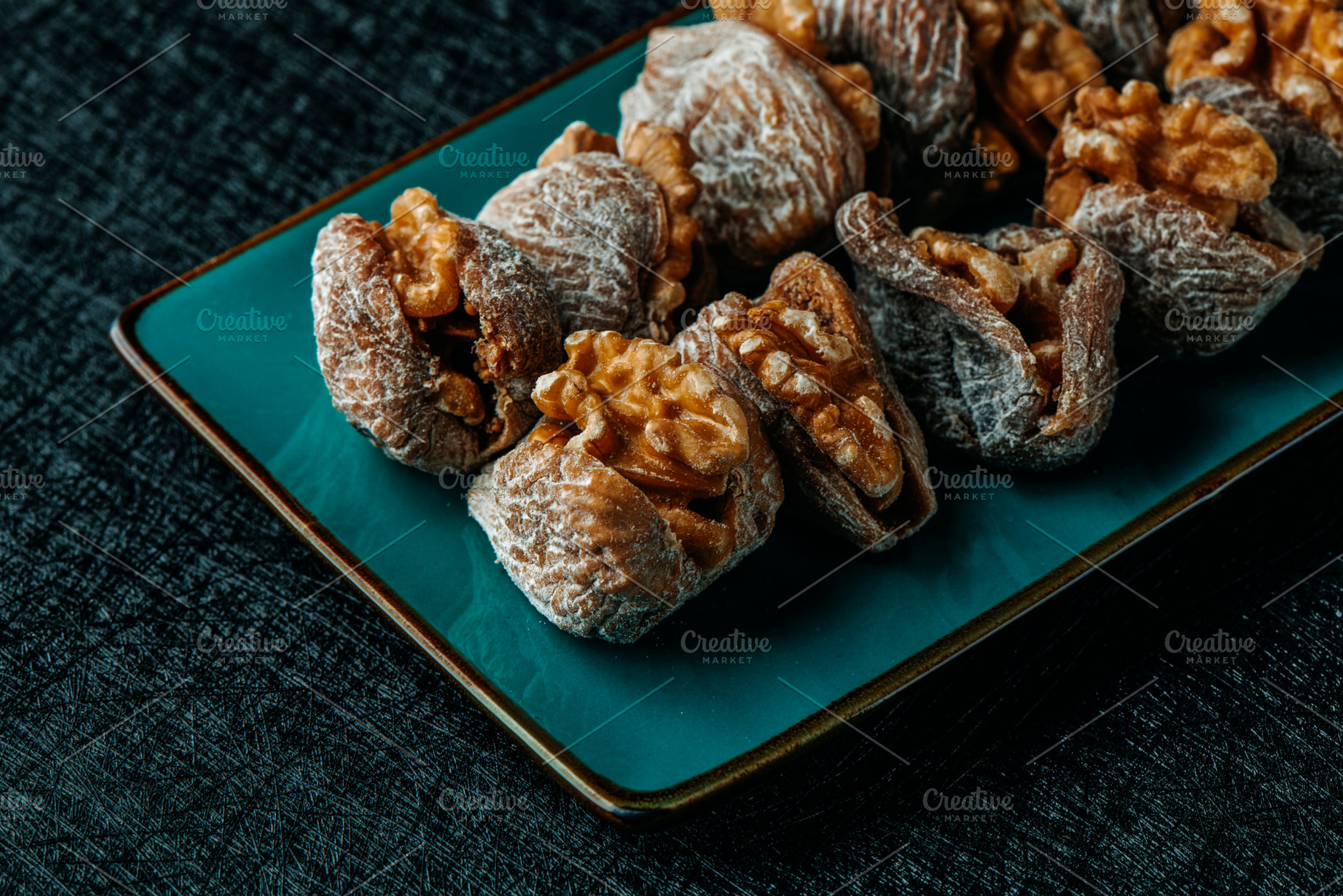 plate with spanish dried figs filled with walnuts, a Photo by Nito