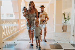 Family entering hotel on summer, a Holiday Photo by HalfPoint