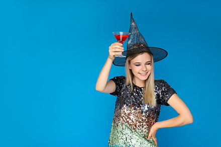 Concept of Halloween, young woman on blue background, a Person Photo by AtlasStudio PRO