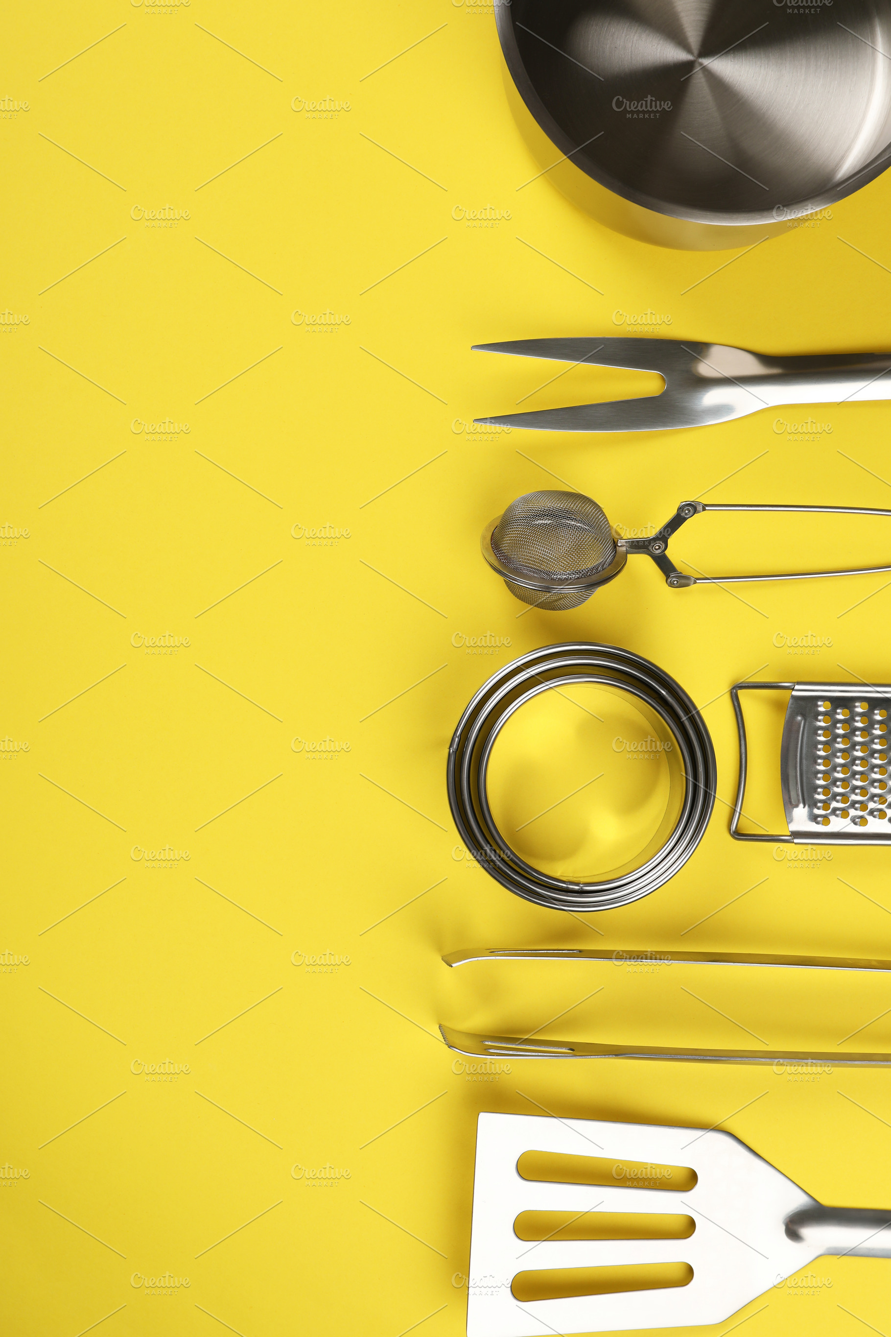 Kitchen utensil on yellow background, space for text, a Food & Drink Photo by AtlasStudio PRO
