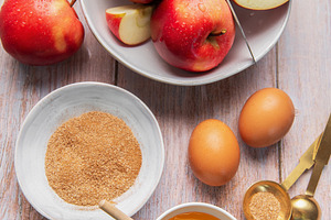 Baking ingredients for apple dessert on wooden table, a Food & Drink Photo by Olena Rudo