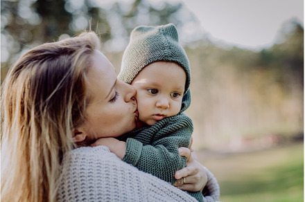 Mother holding and kissing her, a Nature Photo by HalfPoint