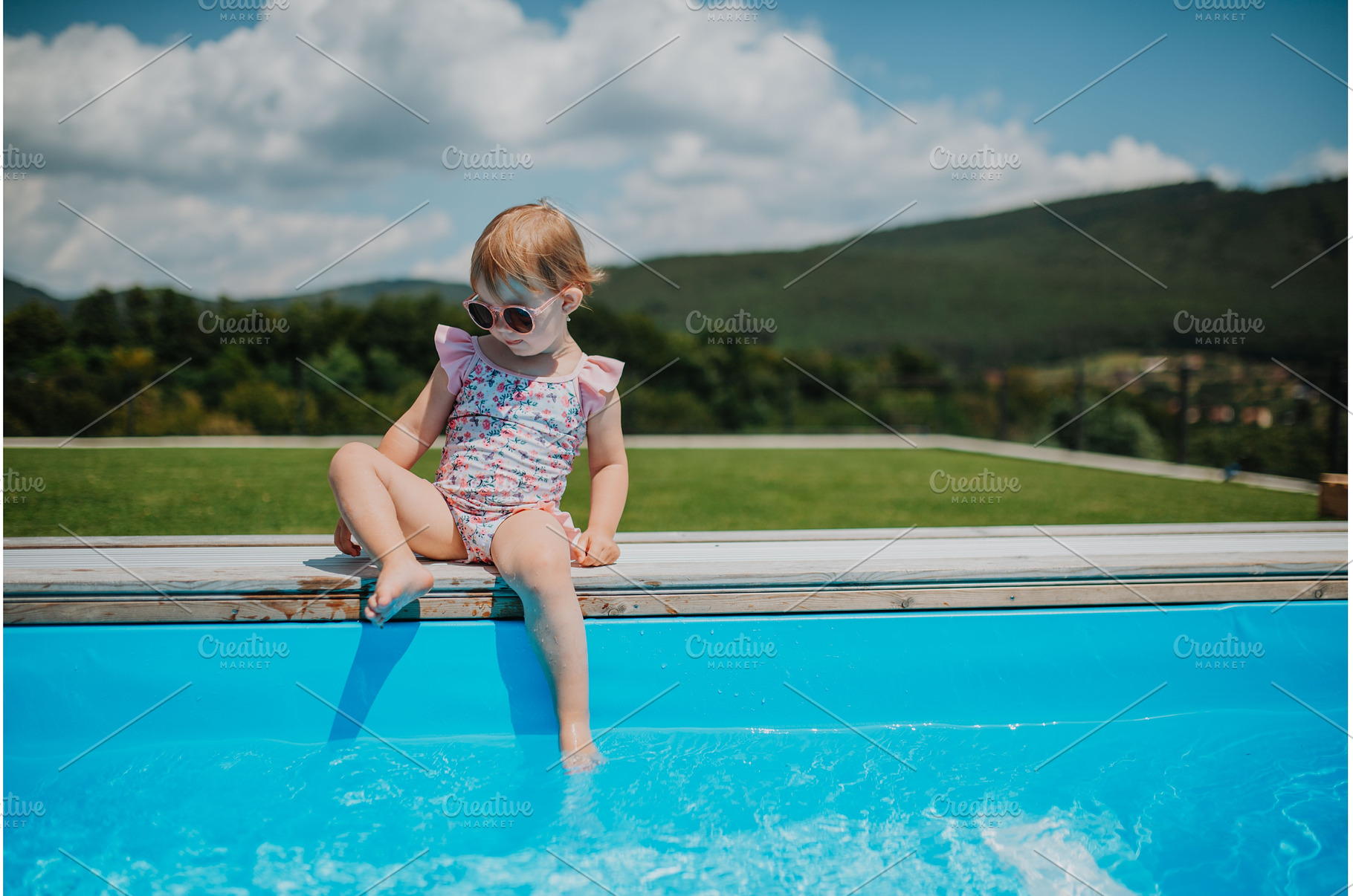 Little girl enjoying summer by the, a Person Photo by HalfPoint