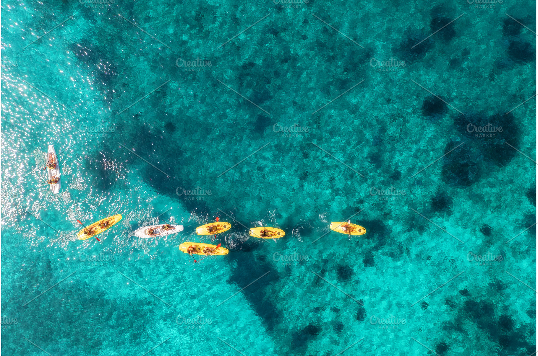 Aerial view of yellow kayaks in blue, a Transportation Photo by den-belitsky