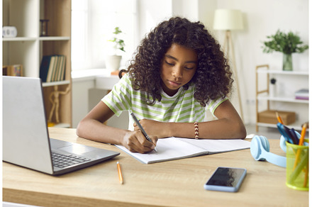 School girl sitting at her desk at, a School & Education Photo by StudioRomantic