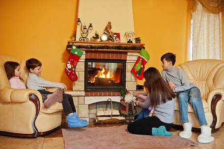 Happy young large family by a fireplace in warm living room on w, a Holiday Photo by AS photostudio