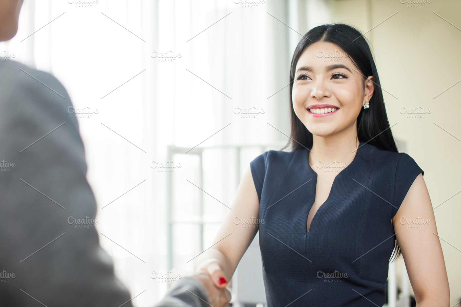 Beautiful asian businesswoman smiling and shaking hands containing asian, a Business Photo by Twinster Photo