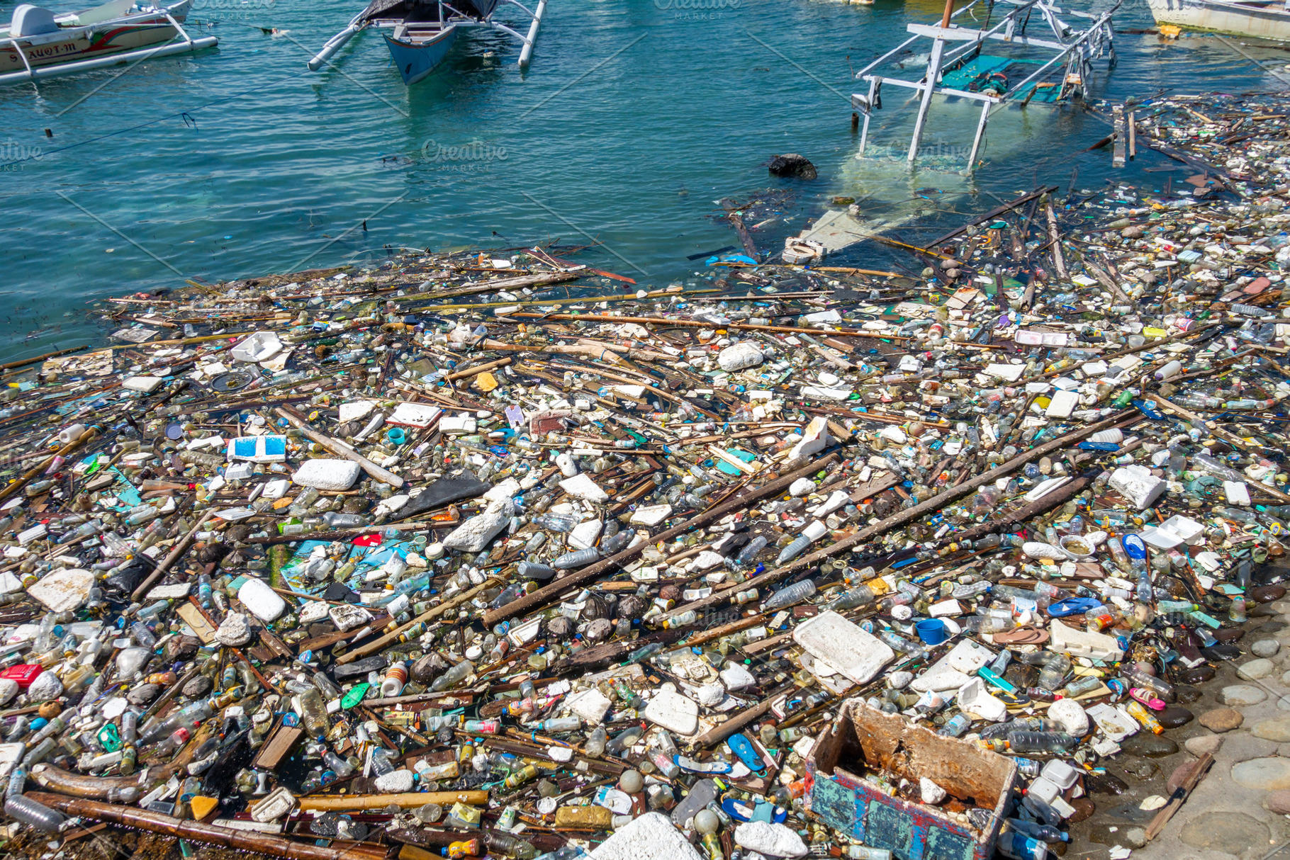 Floating waste pollution in Bira harbor, Sulawesi, Indonesia, a Nature Photo by GoodGoods