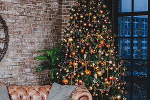 Interior with couch and decorated ch containing ball, bauble, and bead