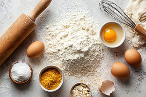 Baking ingredients arranged on a rustic countertop ready for preparation, a Food & Drink Photo by AlyaAnd