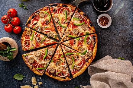 Sausage and vegetable pizza on dark background, a Food & Drink Photo by farwasser