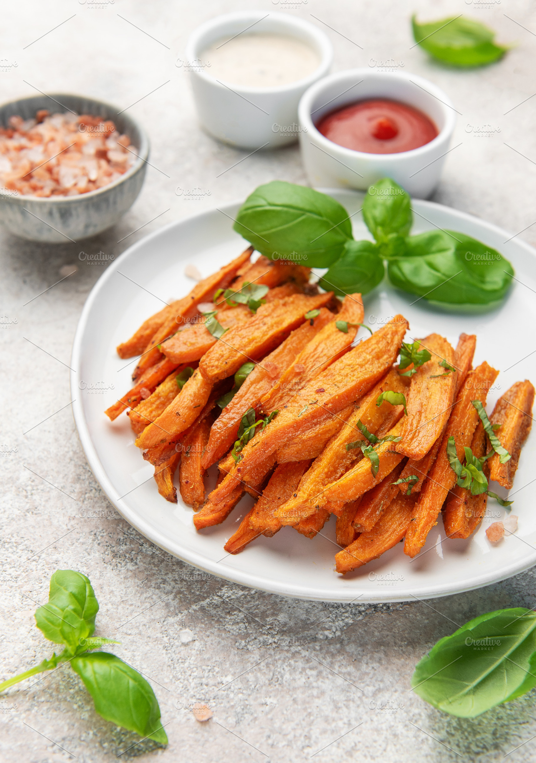 Sweet potato fries with basil, dipping sauce and salt, a Food & Drink Photo by Olena Rudo