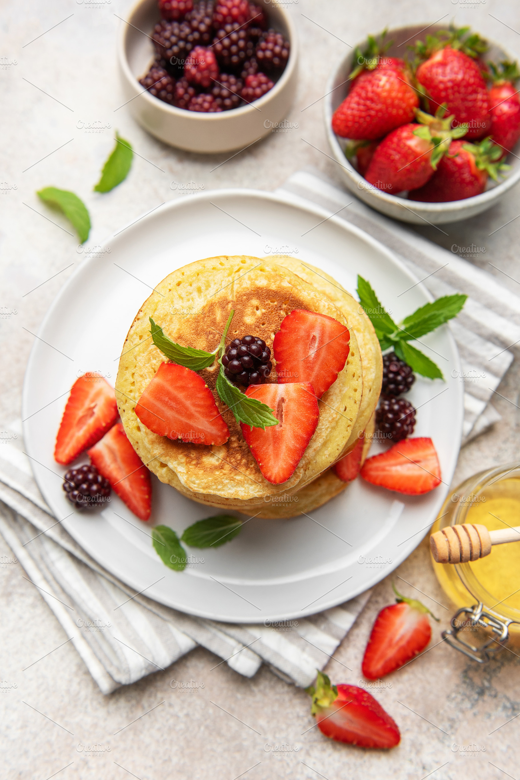 Pancakes with fresh strawberries blackberries honey mint, a Food & Drink Photo by Olena Rudo