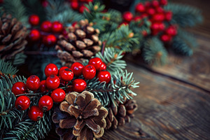 Closeup of festive Christmas wreath with red berries and pinecones on rustic wo, an Industrial Photo by José Manuel Gelpi