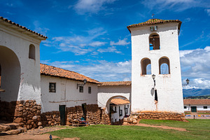Colonial church in Chinchero, Peru, with white adobe bell tower, an Architecture Photo by GoodGoods