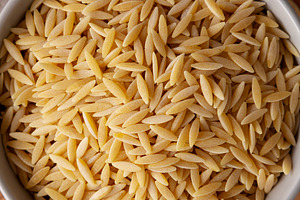 Organic Dried Orzo Pasta in a Bowl, top view., a Food & Drink Photo by LiudmylaChuhunova