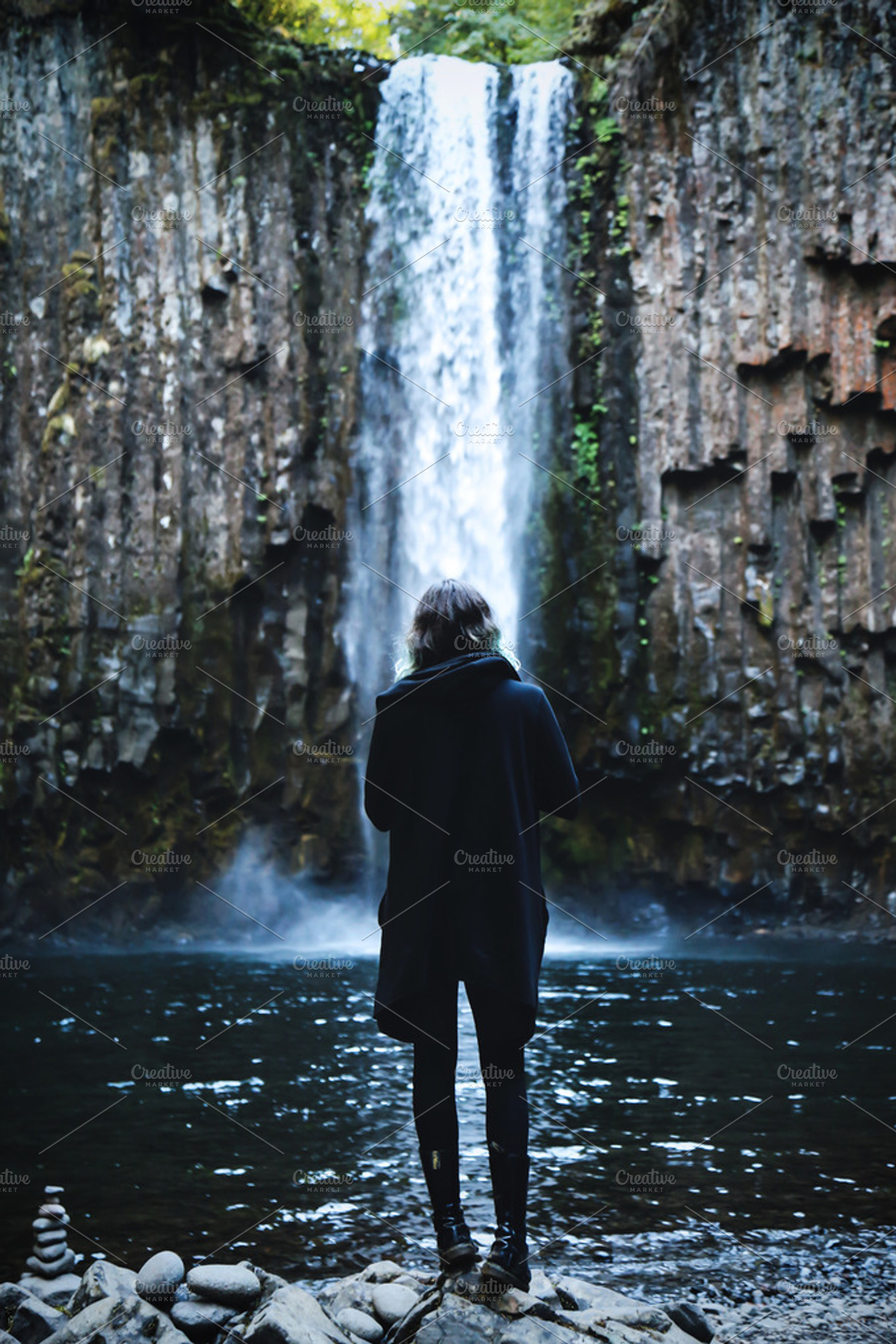 Girl in Coat with Waterfall, a Nature Photo by Dæmon Ex Machina